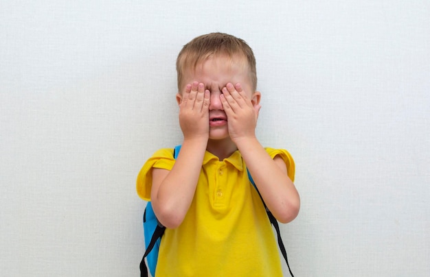 Un retrato de un niño frustrado, una cara triste de un niño, un niño infeliz mirando hacia afuera, un retrato emocional de un bebé, el concepto de niños mimados.