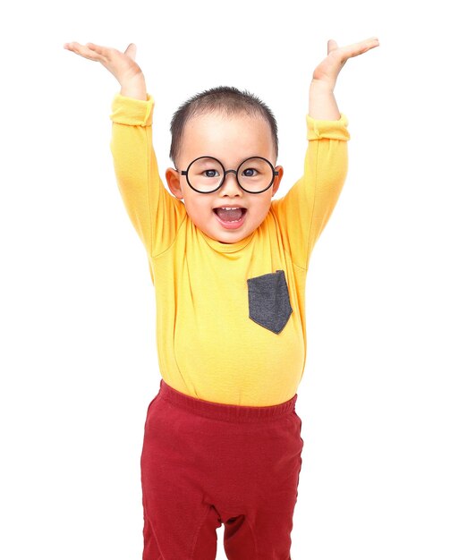 Foto retrato de un niño lindo con los brazos levantados de pie contra un fondo blanco