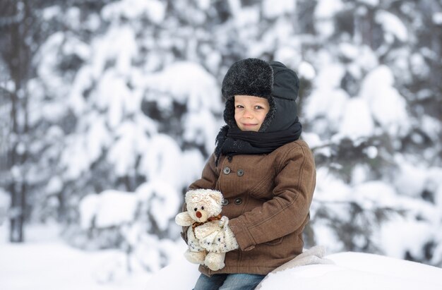 Retrato de un niño pequeño en un bosque de invierno