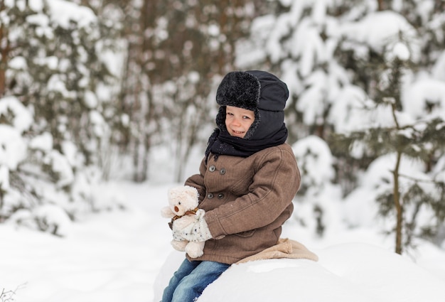 Retrato de un niño pequeño en un bosque de invierno