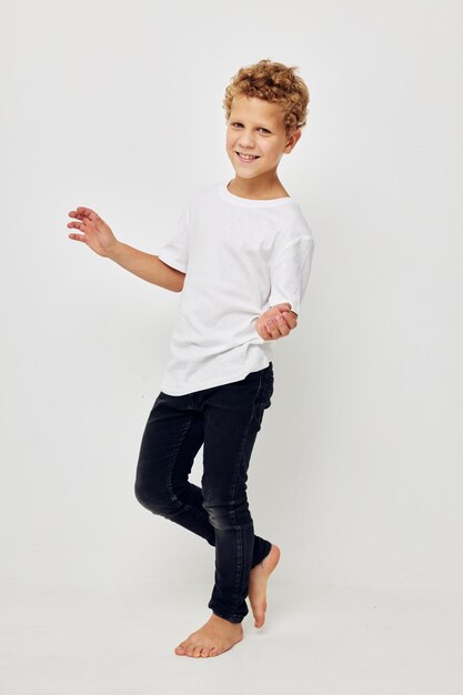 Retrato de un niño de pie contra un fondo blanco