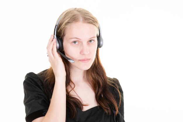 Retrato de operador de teléfono de soporte alegre de mujer seria en centro de llamadas en auriculares de teléfono