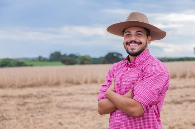 Retrato de un orgulloso agricultor latinoamericano de pie con los brazos cruzados mirando la cámara