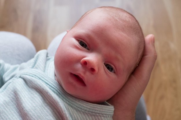 Retrato de una pequeña niña recién nacida caucásica mirando a la cámara