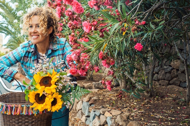 Retrato de personas al aire libre con espacio para copiar Mujer alegre sonriendo y andando en bicicleta con girasoles en Concepto de actividad de ocio activa al aire libre y transporte y estilo de vida saludable