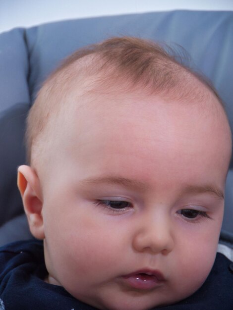 Foto retrato en primer plano de un bebé en una silla alta