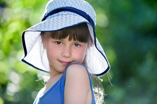 Retrato de primer plano de feliz niña sonriente en un gran sombrero.
