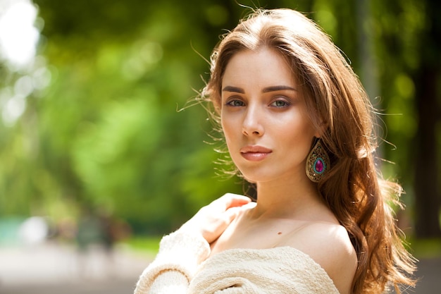 Foto retrato en primer plano de una joven y hermosa mujer morena en el fondo de verano