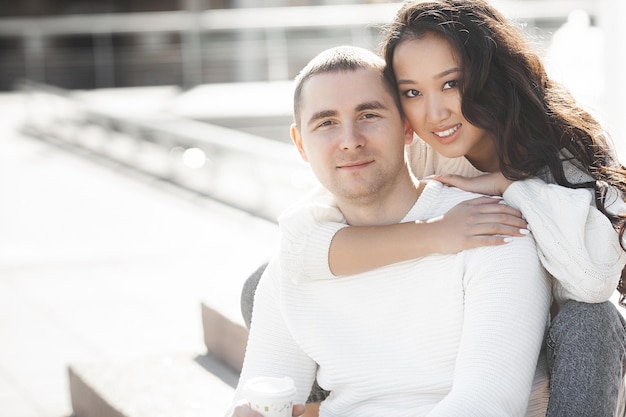 Retrato de primer plano de una joven pareja multirracial encantadora. Gente al aire libre. Hombre y mujer felices divirtiéndose en la ciudad.