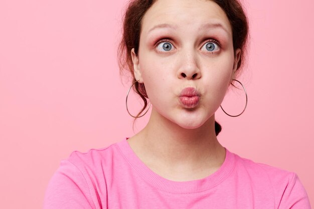 Retrato en primer plano de una mujer joven contra un fondo rosado