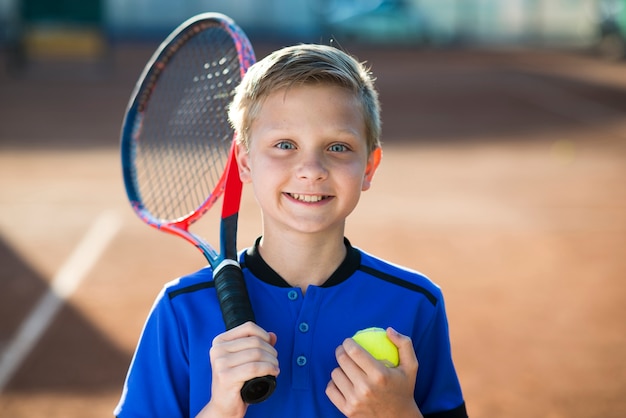 Foto retrato de primer plano de niño en el campo de tenis