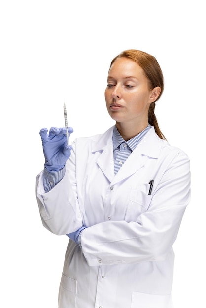 Retrato recortado de la enfermera del trabajador médico de la mujer con suringe posando aislada sobre fondo blanco