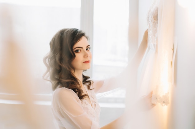 Retrato romántico de una hermosa niña con un vestido en el interior