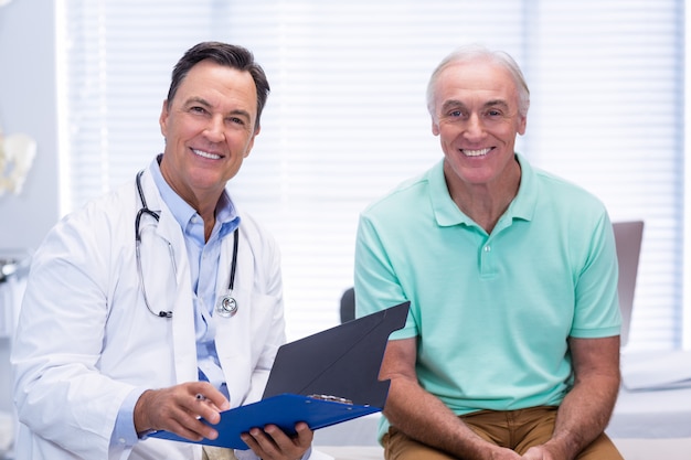 Retrato de sonriente médico y paciente senior