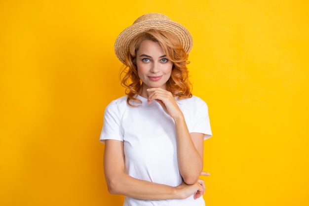 Retrato sonriente de una mujer bastante joven con sombrero de paja sobre fondo amarillo Chica feliz disfrutando del verano