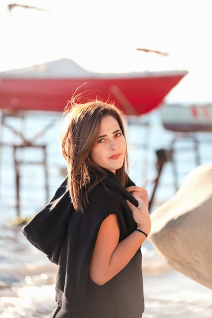 Retrato vertical al aire libre de joven bella mujer en la playa