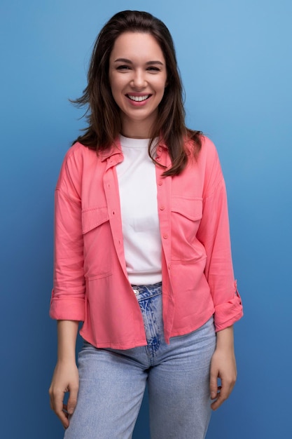 Retrato vertical de una joven morena con camisa y jeans