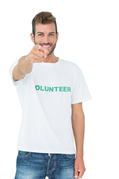 Retrato de un voluntario masculino feliz que le señala