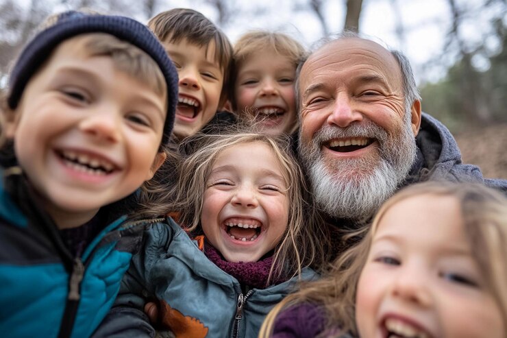 Una reunión alegre de niños riendo con un hombre mayor en un paisaje de invierno