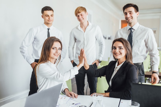 Reunión de negocios exitosa de colegas jóvenes y hermosos en la oficina