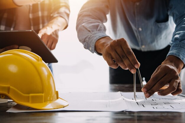 Reunión de trabajo en equipo de ingenieros Trabajo de dibujo en una reunión de planos para un proyecto que trabaja con un socio en la construcción de modelos y herramientas de ingeniería en el lugar de trabajo Concepto de construcción y estructura