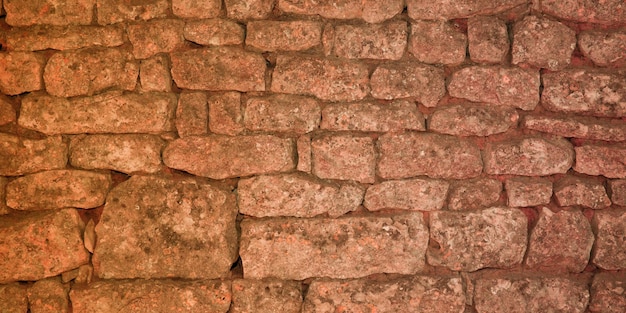 Revestimiento de fondo de piedra marrón con textura de pared de piedras de diferentes tamaños beige oscuro