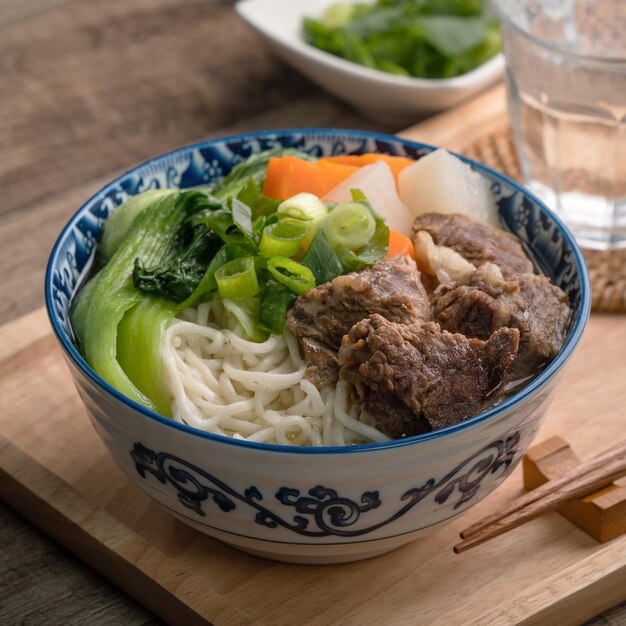 Rindfleisch-Nudelsuppe Nahaufnahme des berühmten taiwanesischen Essens in einer Schüssel auf einem Holztisch