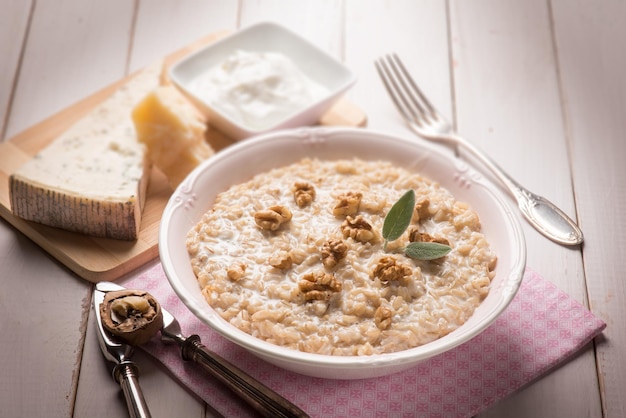 Risoto com nozes gongorzola e foco seletivo de molho de natas