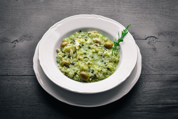 Risoto com queijo de espinafre e azeitonas Em um fundo de madeira Vista superior Espaço livre