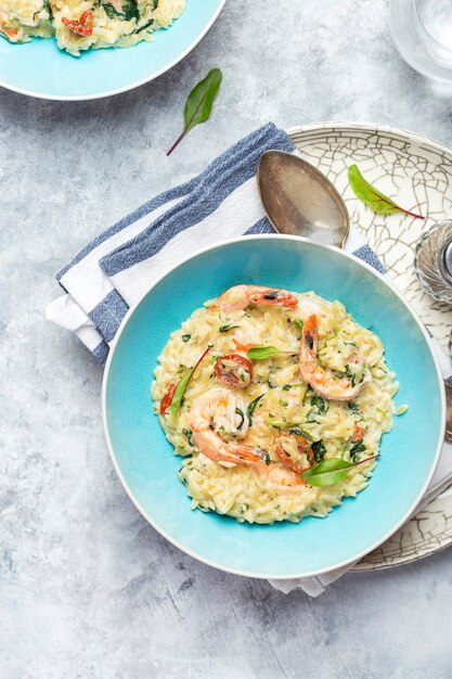 Risoto de ala de massa orzo com camarão rei, tomate seco e espinafre