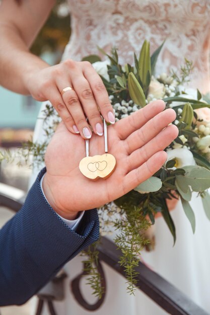 rituales de bodas de primer plano manos de jóvenes colgando una cerradura en el amor al aire libre en Ucrania