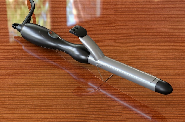 Rizador de pelo de hierro rizado en la representación 3D de la mesa de madera