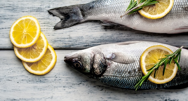 Robalo de peixe fresco. Robalo peixe cru com ingredientes especiarias e ervas em fundo de madeira