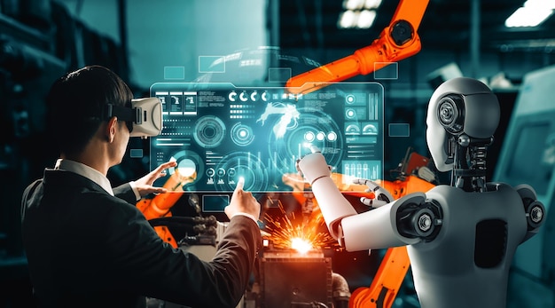 Robot industrial mecanizado y trabajador humano trabajando juntos en la fábrica del futuro