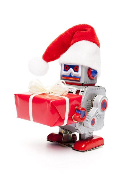 Foto robot de santa de juguete de hojalata retro con regalo de navidad