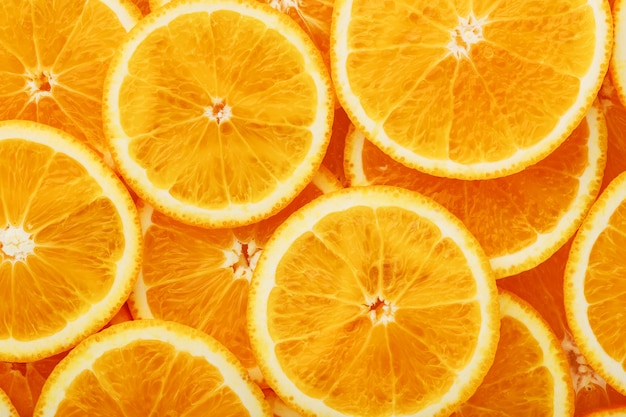 Foto rodajas de naranja redondas, en forma de textura y linternas de rodajas jugosas frescas