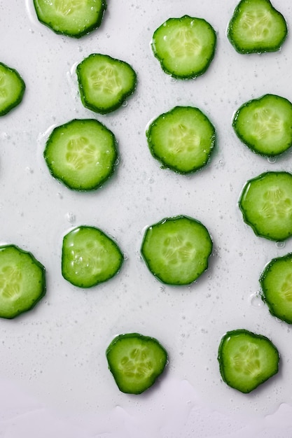 Rodajas de pepino planas con gel sobre fondo blanco planta medicinal natural para cosmética orgánica medicina alternativa salud y belleza concepto de spa espacio de copia