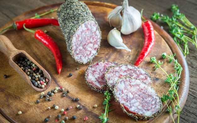 Rodajas de saucisson sobre la plancha de madera