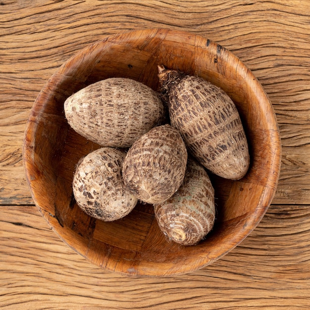 Rohe Yamswurzeln oder Inhames auf einer Schüssel über Holztisch.