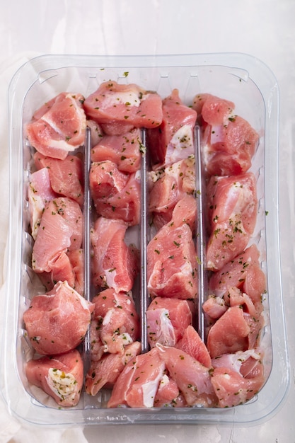 Rohes Putenfleisch mit Kräutern in Plastikbox