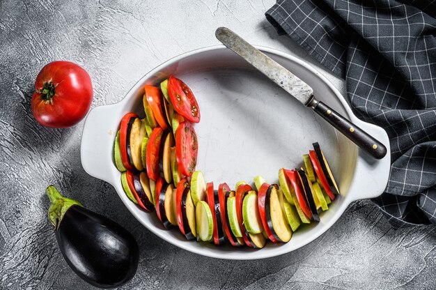 Rohes Ratatouille, traditionelles französisches Gemüsegericht. Grauer Hintergrund. Draufsicht.