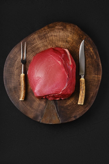 Rohes Rindfleisch, rundes Fleisch auf Holzplatte