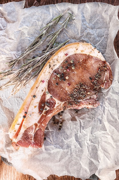 Rohes Schweinekotelett mit Rosmarin.