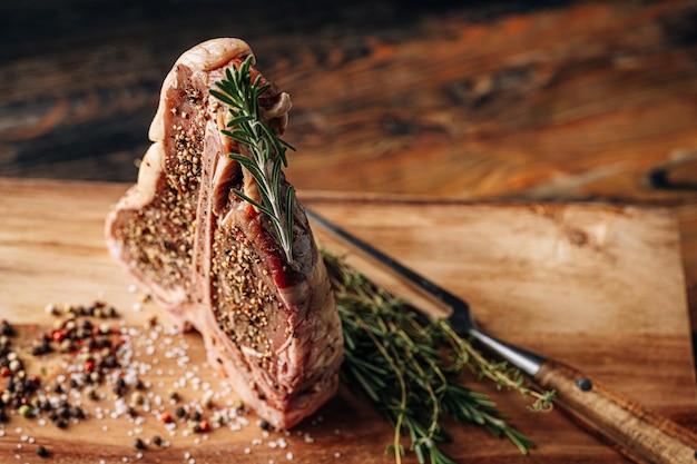 Foto rohes tbone-steak mit gewürzen zum braten