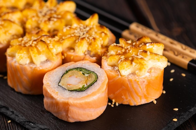 Rolle mit Fischsushi mit Essstäbchen Nahaufnahme asiatisches japanisches Lebensmittelkonzept