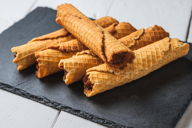 Foto rollos de oblea con leche condensada waffle fino y crujiente enfoque selectivo