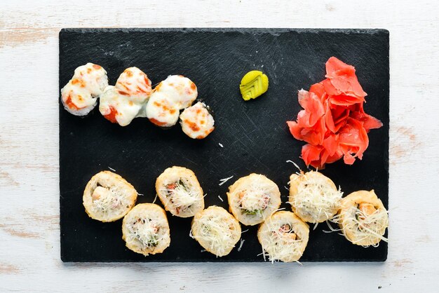 Rollos de sushi y maki en un plato Vista superior Espacio libre para su texto Sobre un fondo blanco