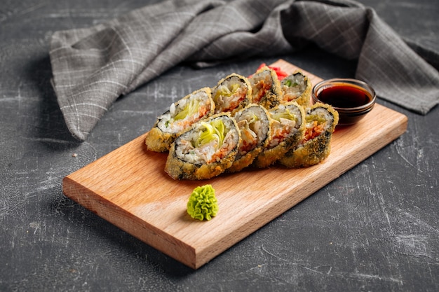 Rollos de sushi tempura asados con lechuga y salsa