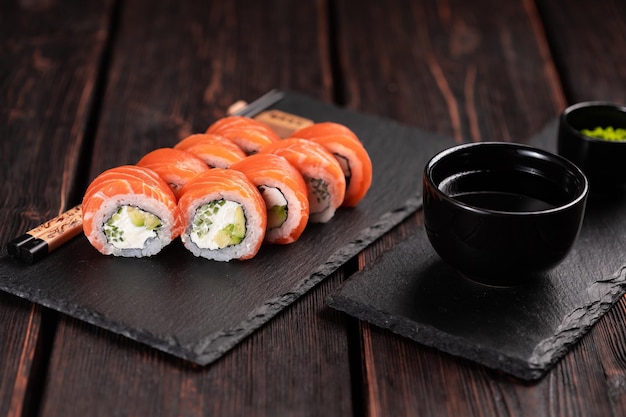 Rolo com sushi de peixe com pauzinhos conceito de comida asiática