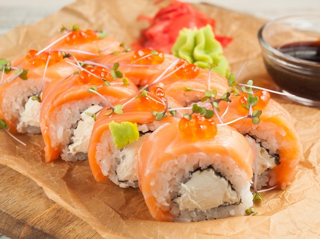 Rolos de sushi de salmão da filadélfia com molho de soja.